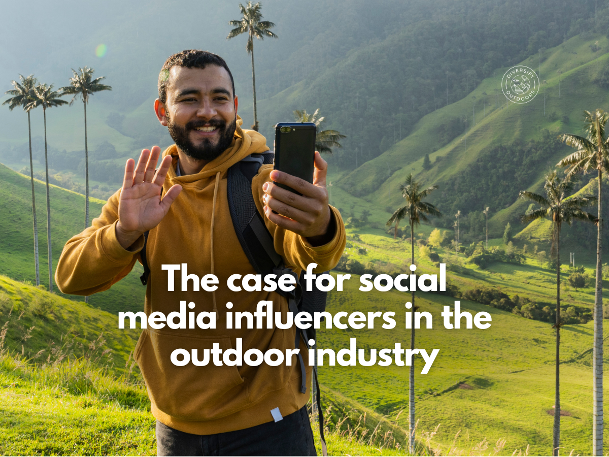Bearded light-skinned man taking mobile camera phone selfie in front of scenic valley