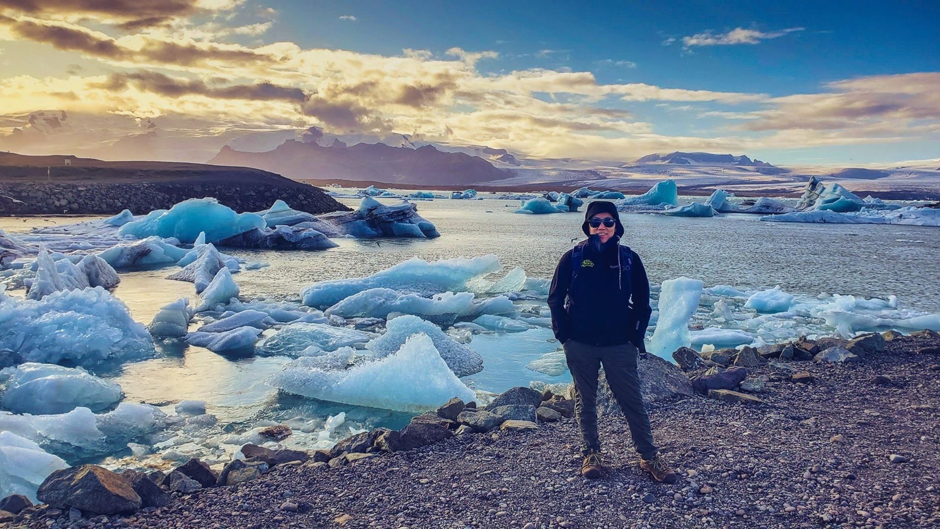 Light-skinned femme standing on an ice shoreline